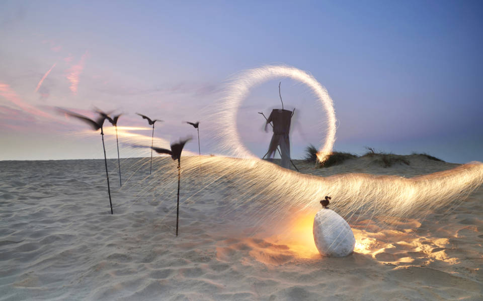 Publicity image for NNF18 show Wayfaring, taken on a beach. In the foreground is a massive egg, a tiny bird sits on top of it.