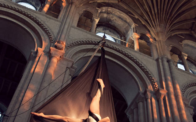 Photo from NNF12 show How Like An Angel, a circus performer hangs from some silk in the Norwich Cathedral.