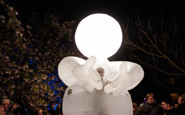 Photo from NNF13 show Reve dHerbert, a man dressed all in white, standing within a huge white glowing suit.