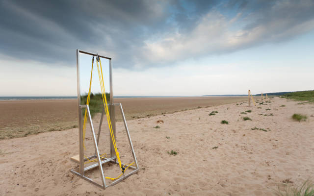 A large free standing mirror on Holkham Beach.