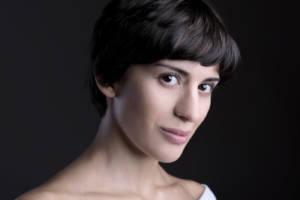 Mariam Batashvili looks into the camera, a black background is behind her.