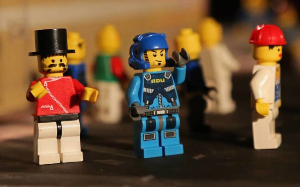 Little Lego figures standing in a row.