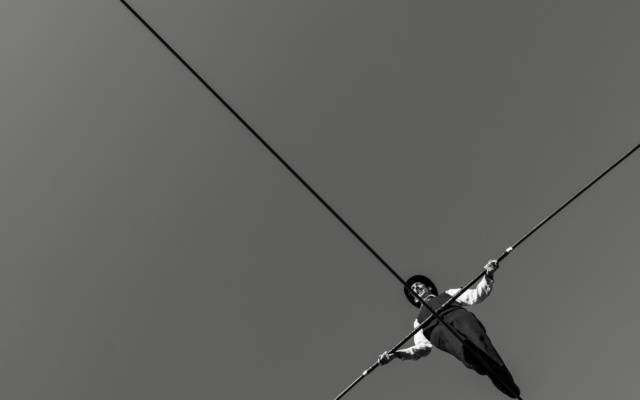 Black and white image of a man on a high-wire