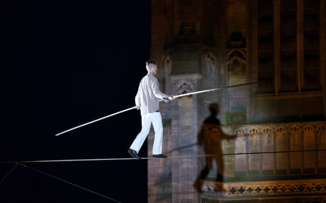 Chris Bullzini walking the highwire in front of St Peter Mancroft Church, his shadow on the church tower.